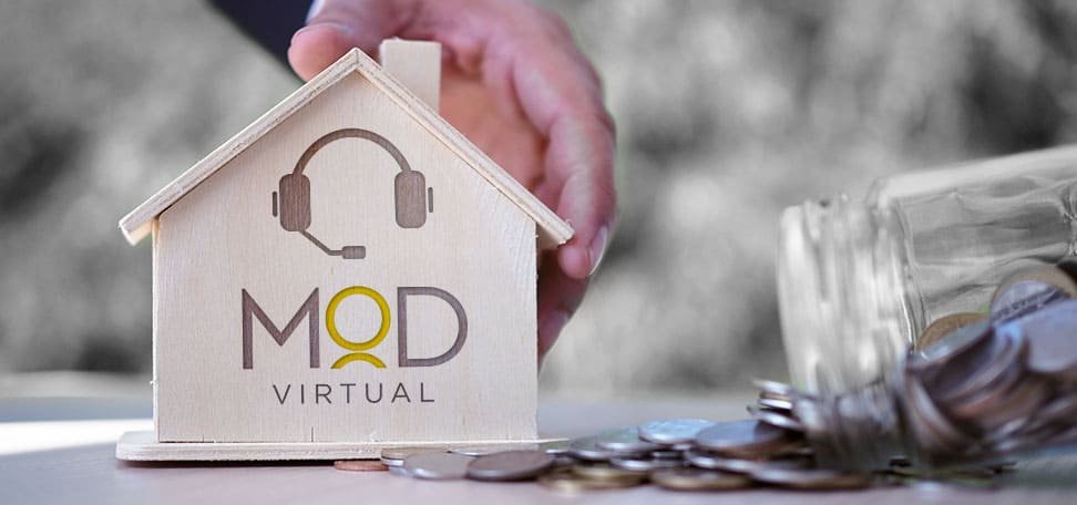 hand holding a wooden house with myoutdesk logo