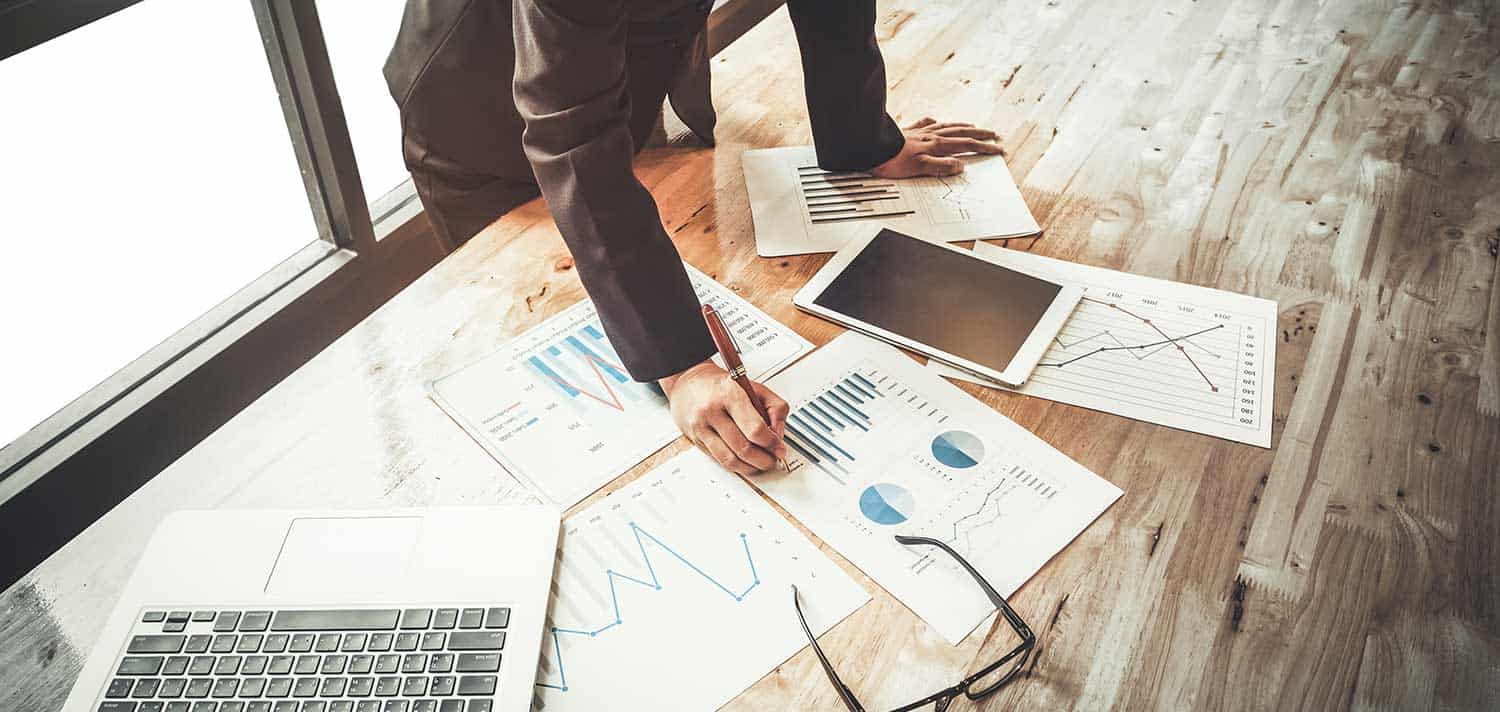 person working at his desk on some charts