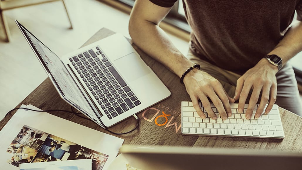 a myoutdesk virtual assistant working at his laptop