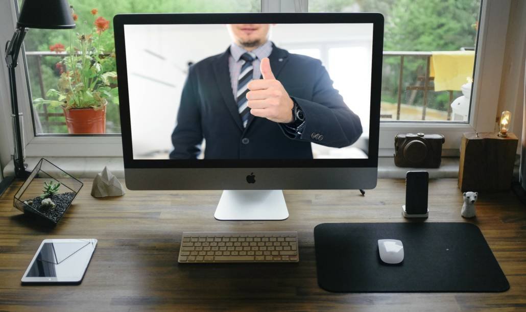virtual man on screen giving thumbs up onboarding a virtual assistant