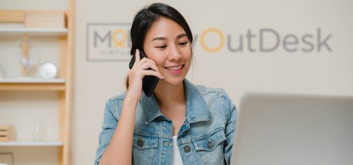virtual assistant at home calling with myoutdesk logo at the wall