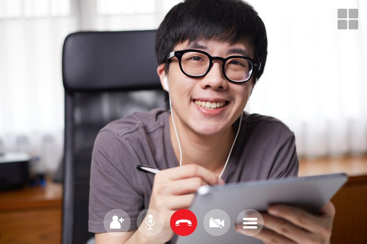 Asian man writing on his tablet